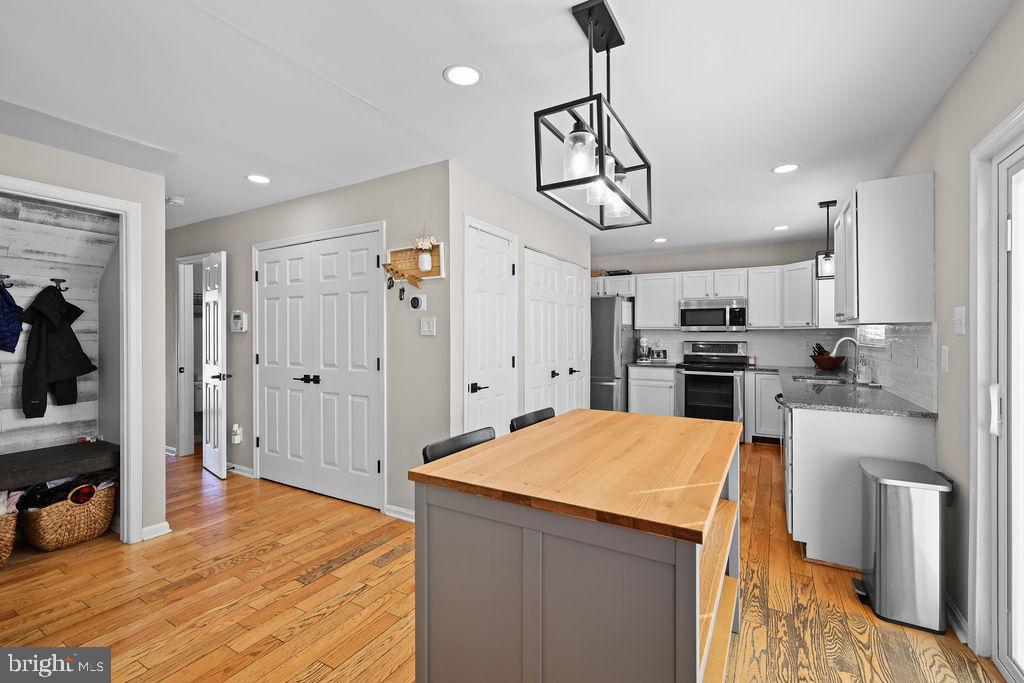 4445 Rolling Acres Drive Hurlock, MD 21643 - Photo 35 of 35 a kitchen with stainless steel appliances a refrigerator and a wooden floor