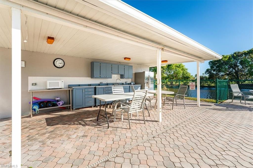 5515 Rattlesnake Hamm Road, Unit 301 Naples, FL 34113 - Photo 25 of 31 Community Pool Patio Area