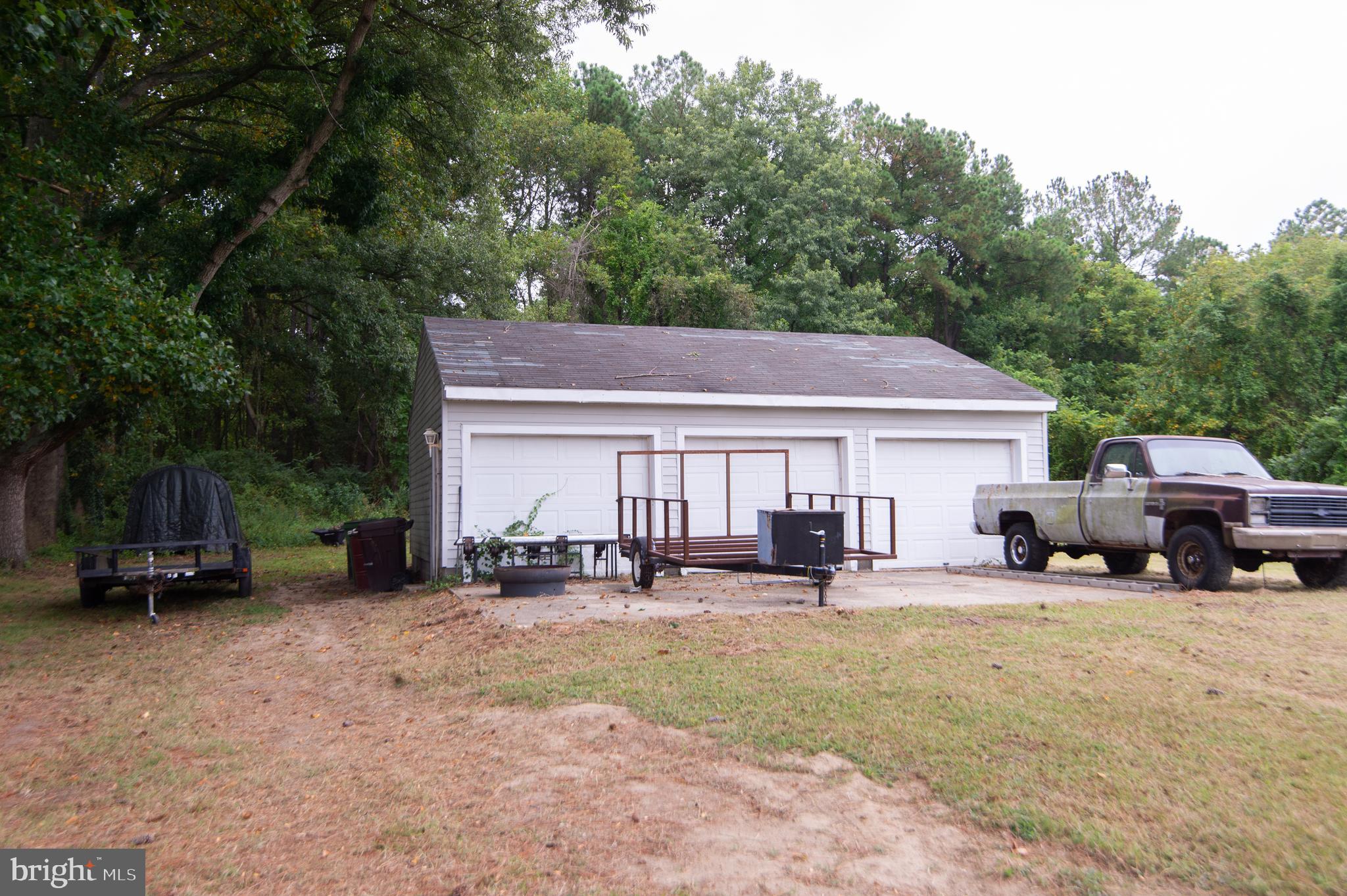 7009 Beulah Road Hurlock, MD 21643 - Photo 21 of 29 a couple of chairs and a table under an umbrella