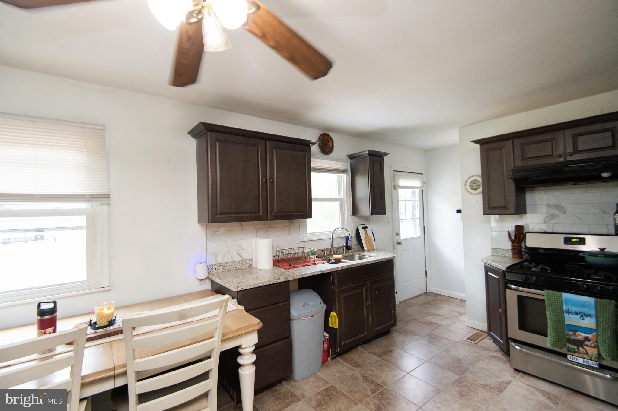 7009 Beulah Road Hurlock, MD 21643 - Photo 3 of 29 a kitchen with a sink appliances and cabinets