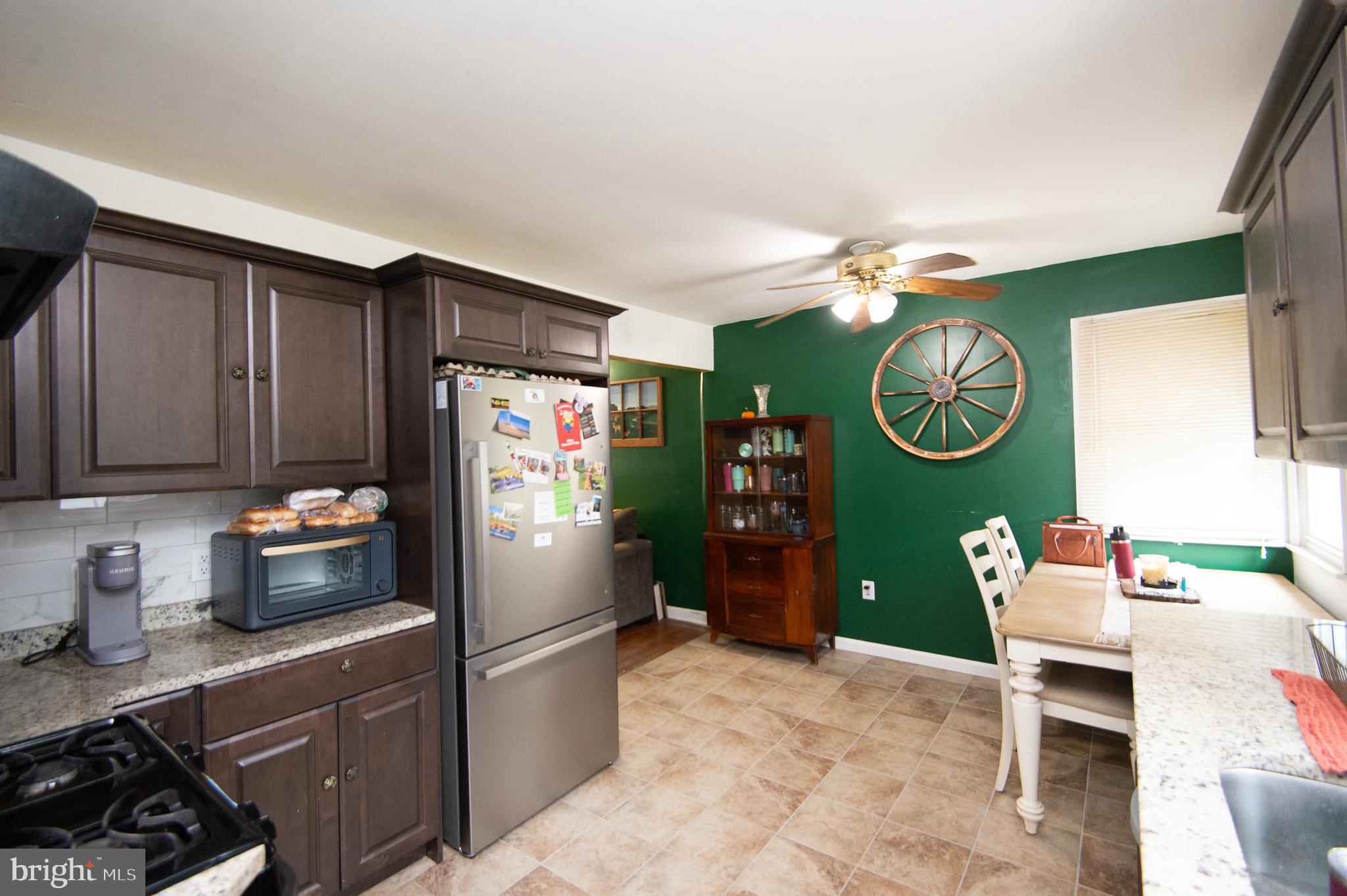 7009 Beulah Road Hurlock, MD 21643 - Photo 6 of 29 a kitchen with a refrigerator and a stove top oven