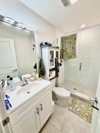 a bathroom with a sink toilet and shower