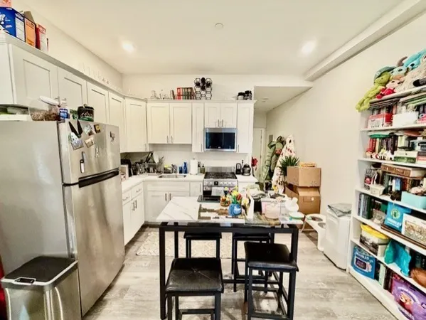 a view of a dining room with furniture and a book shelf