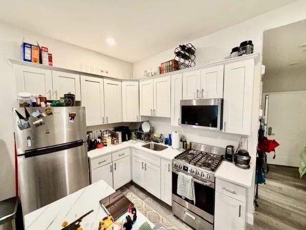 a kitchen with a appliances and a refrigerator