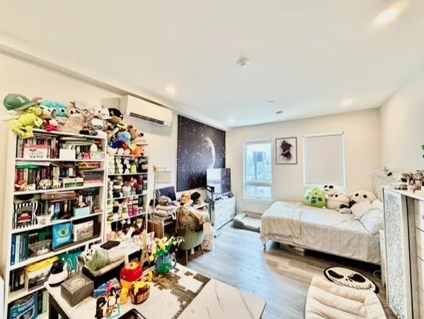 a bedroom with furniture and a book shelf