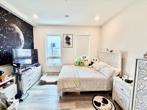 a bedroom with a bed and flat screen tv