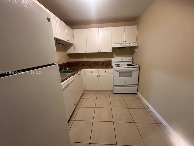 9001 Southwest 77th Avenue, Unit C705 Miami, FL 33156 - Photo 6 of 11 a kitchen with a sink a stove top oven and white stainless steel appliances