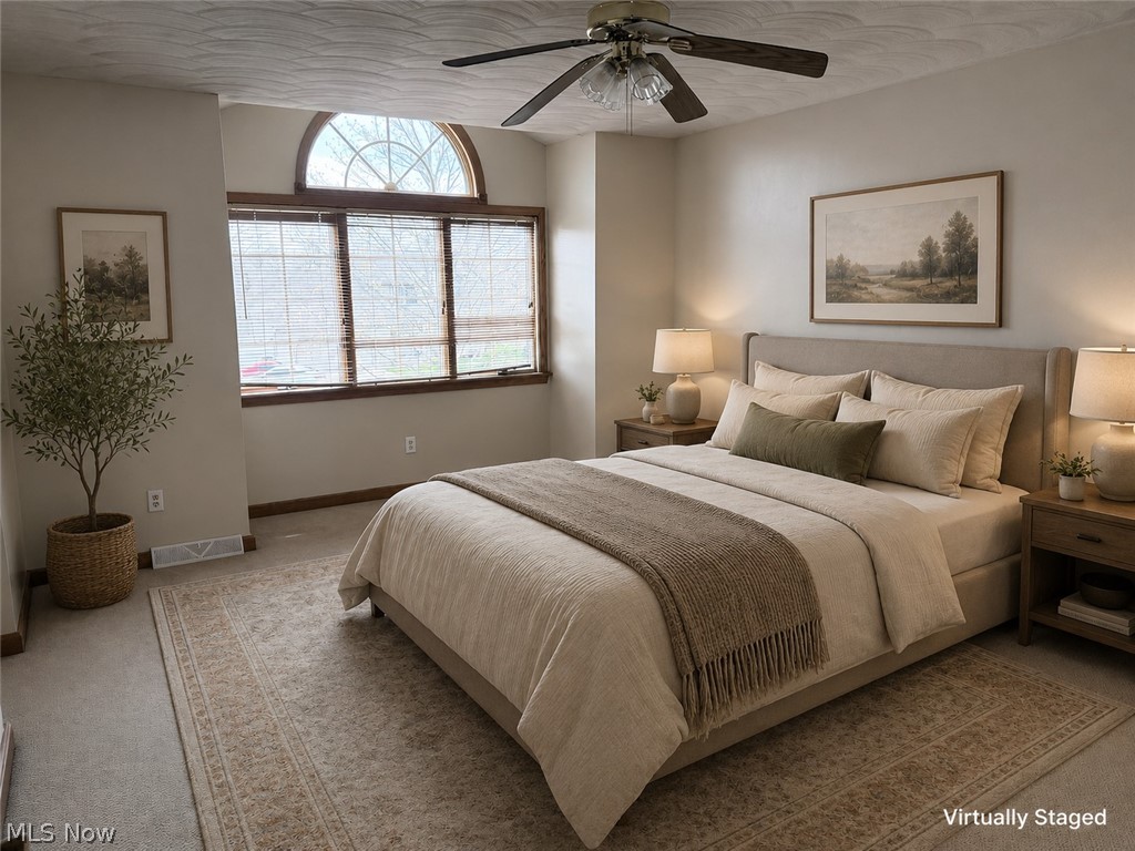 6416 Ridgeview Avenue Youngstown, OH 44515 - Photo 8 of 15 Bedroom featuring a vaulted ceiling with a ceiling fan, a large window with an arched transom, and carpeted flooring