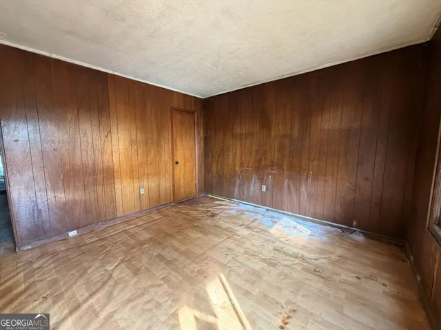 a view of an empty room and wooden door