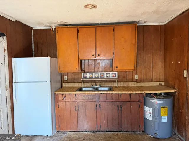 a kitchen with stainless steel appliances a refrigerator and a stove