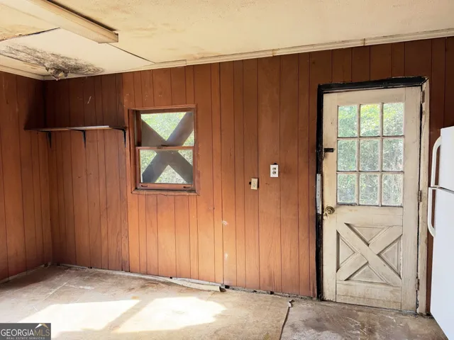 an empty room with windows and closet