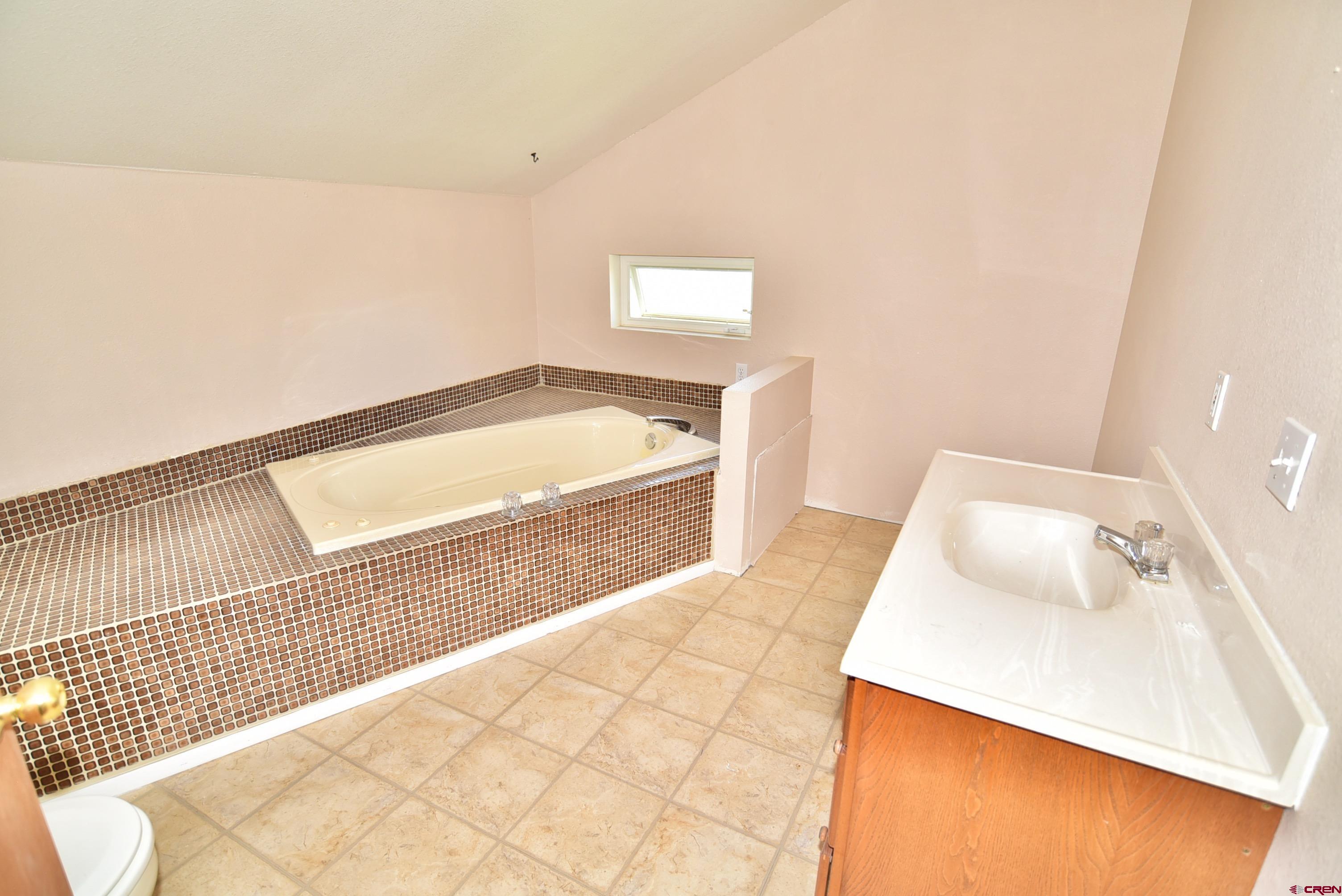 68600 Kinikin Road Montrose, CO 81403 - Photo 20 of 44 a bathroom with a bathtub and shower
