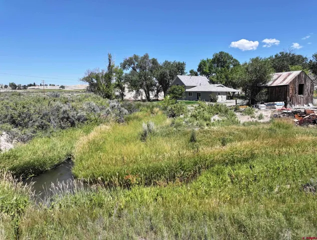 a view of a house with a yard and a pool