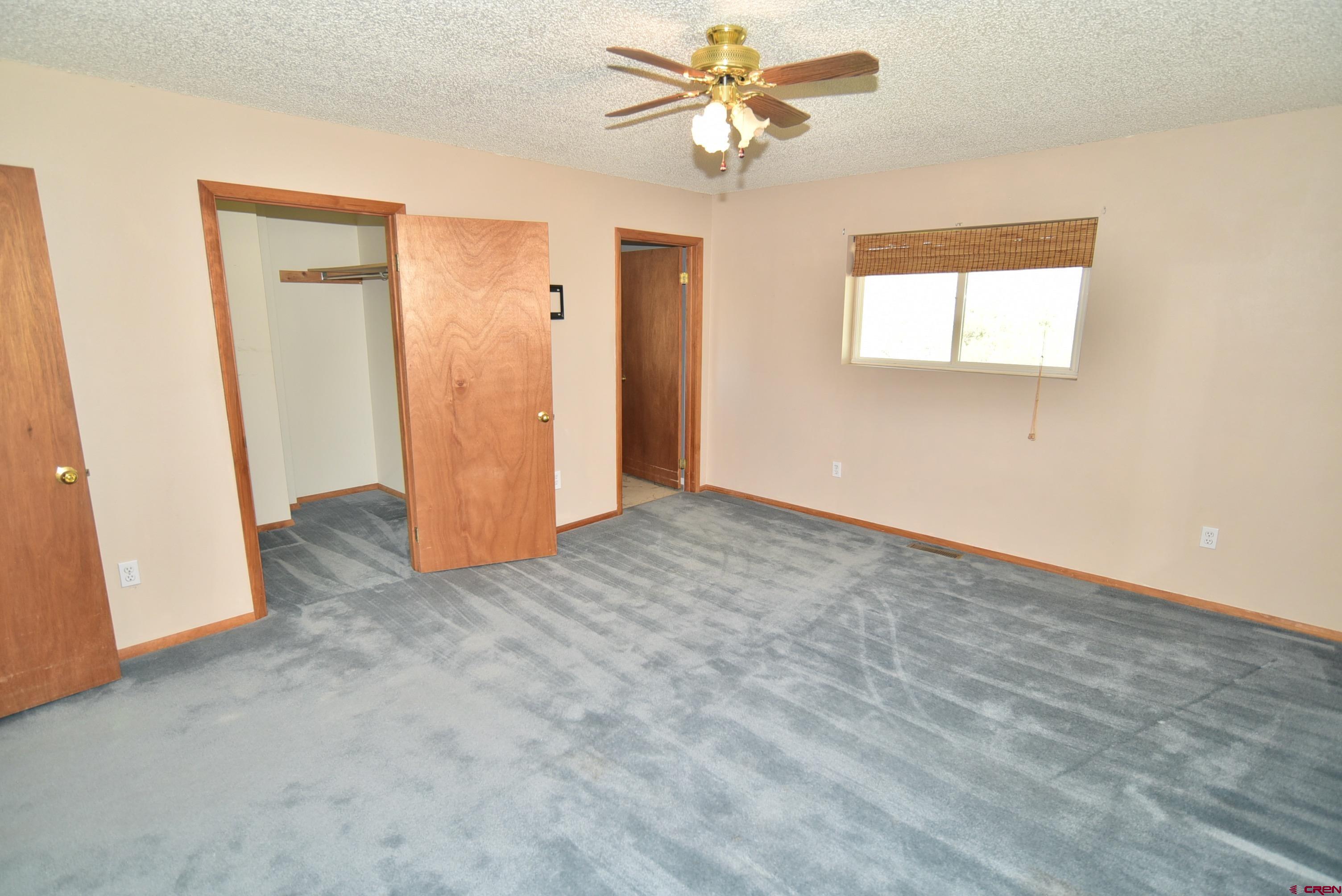 68600 Kinikin Road Montrose, CO 81403 - Photo 21 of 44 a view of a livingroom with a ceiling fan and window