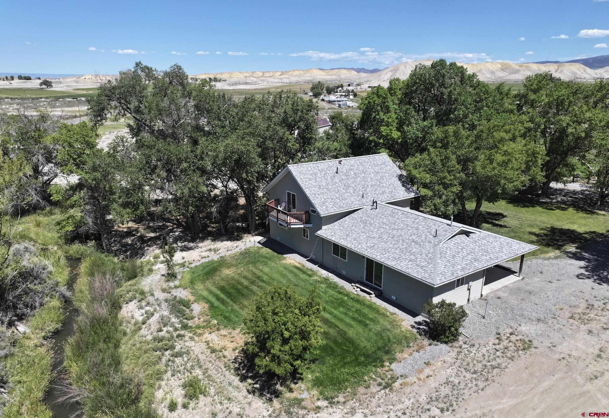 68600 Kinikin Road Montrose, CO 81403 - Photo 32 of 44 a wooden bench sitting in the middle of a yard
