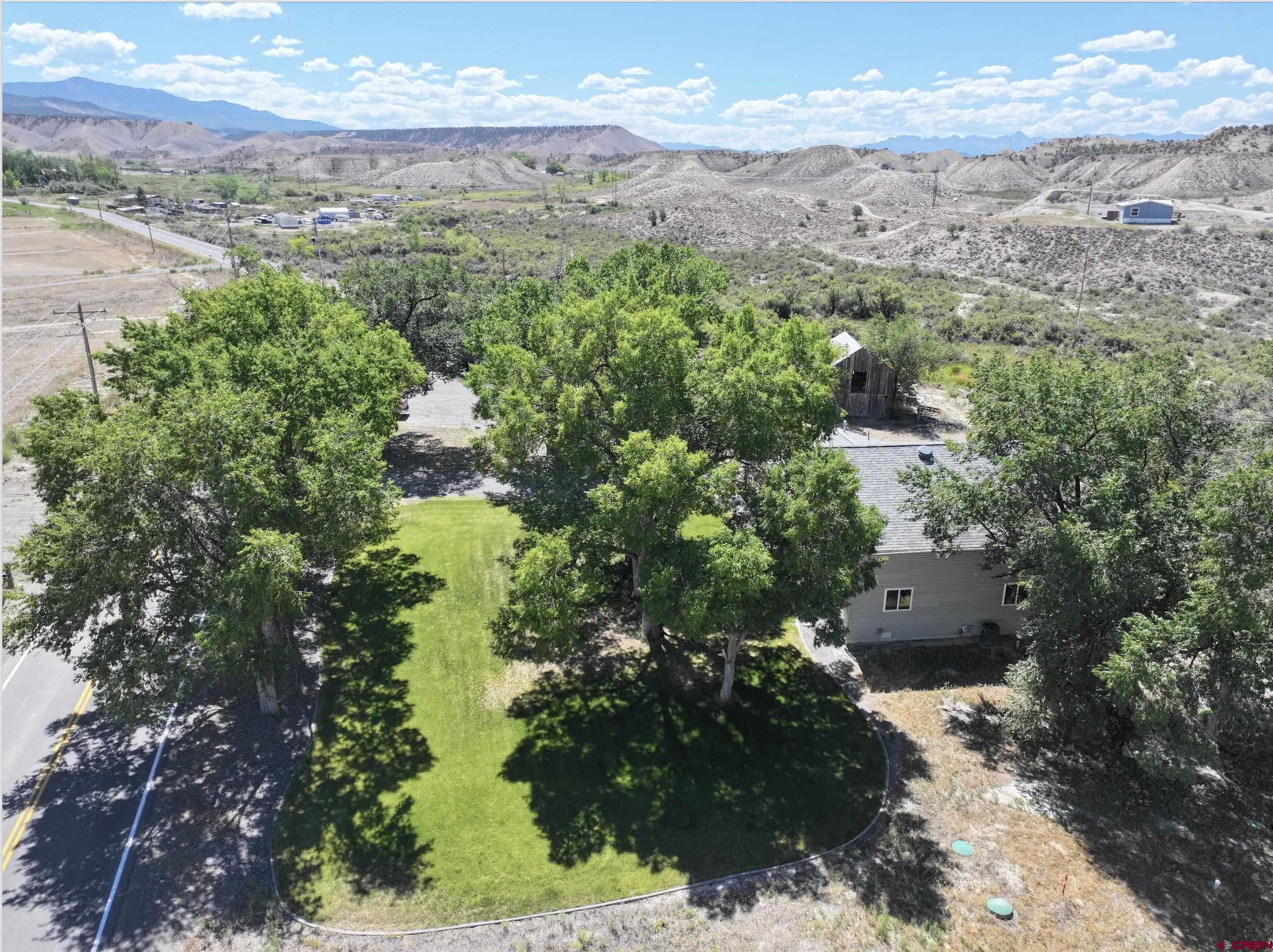 68600 Kinikin Road Montrose, CO 81403 - Photo 36 of 44 a view of a city with mountains in the background