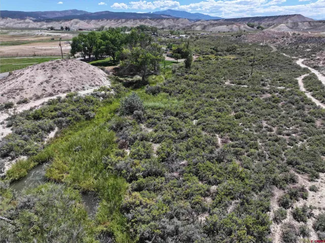 an aerial view of a house with a yard