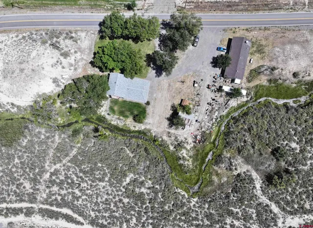 an aerial view of a house with a yard