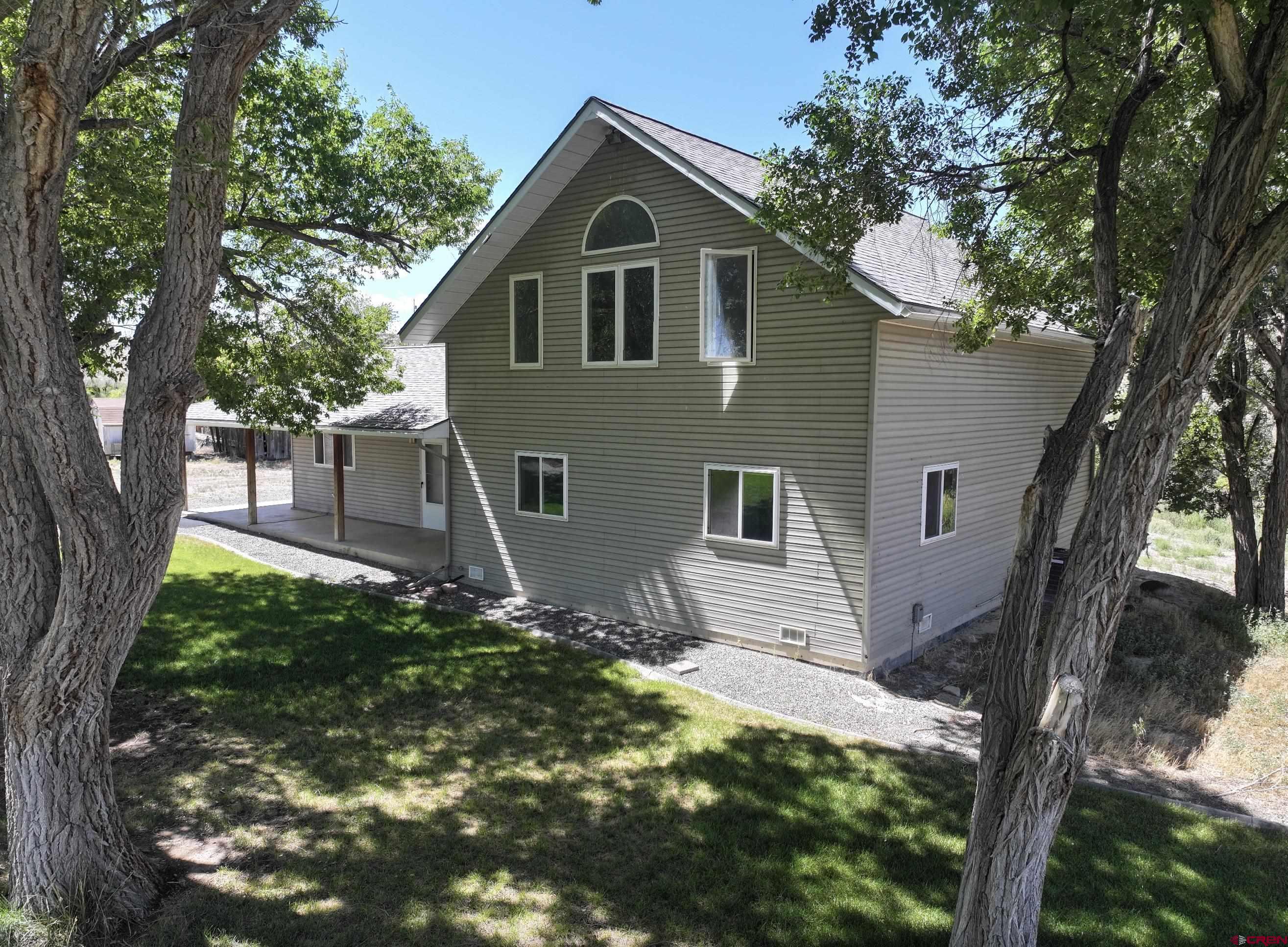 68600 Kinikin Road Montrose, CO 81403 - Photo 4 of 44 a front view of a house with garden