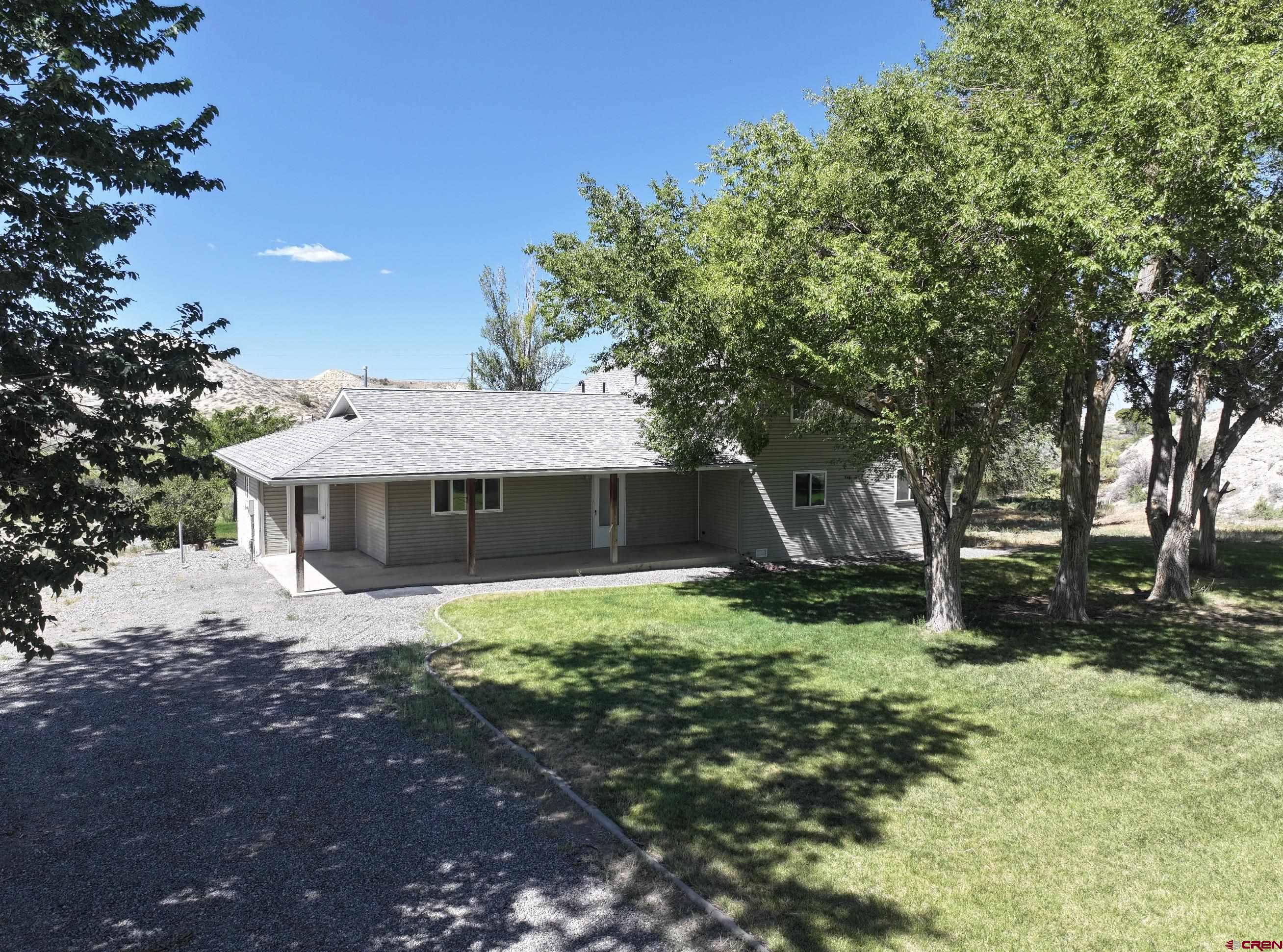 68600 Kinikin Road Montrose, CO 81403 - Photo 5 of 44 a house that has a tree in it