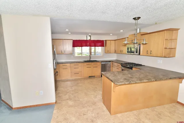 a kitchen with a sink cabinets and window
