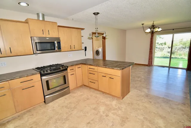 a kitchen with stainless steel appliances granite countertop a stove and a sink