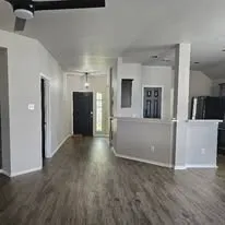 a view of a kitchen with a sink and a refrigerator