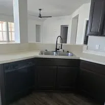 a kitchen with a sink and a mirror