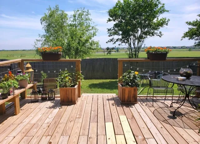 a view of a deck with wooden floor and seating space