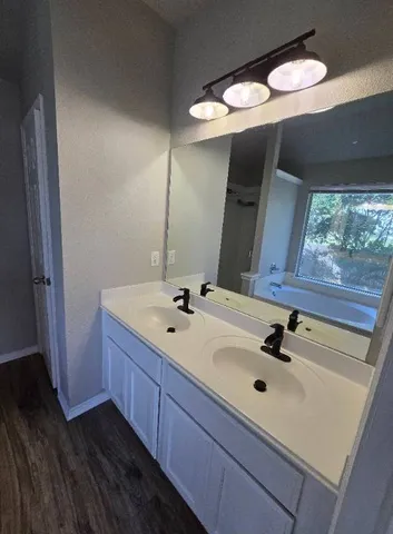 a bathroom with a glass shower door