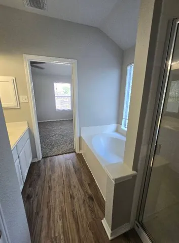 a view of room with wooden floor