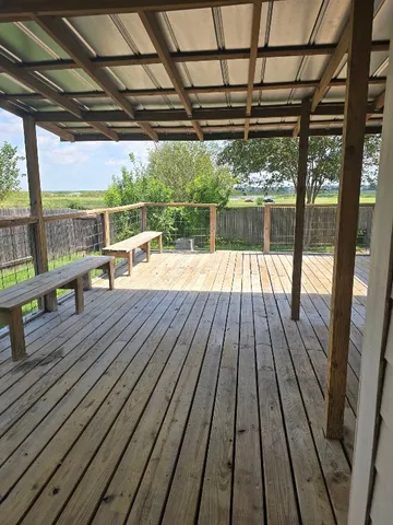 a view of backyard with small cabin and wooden fence