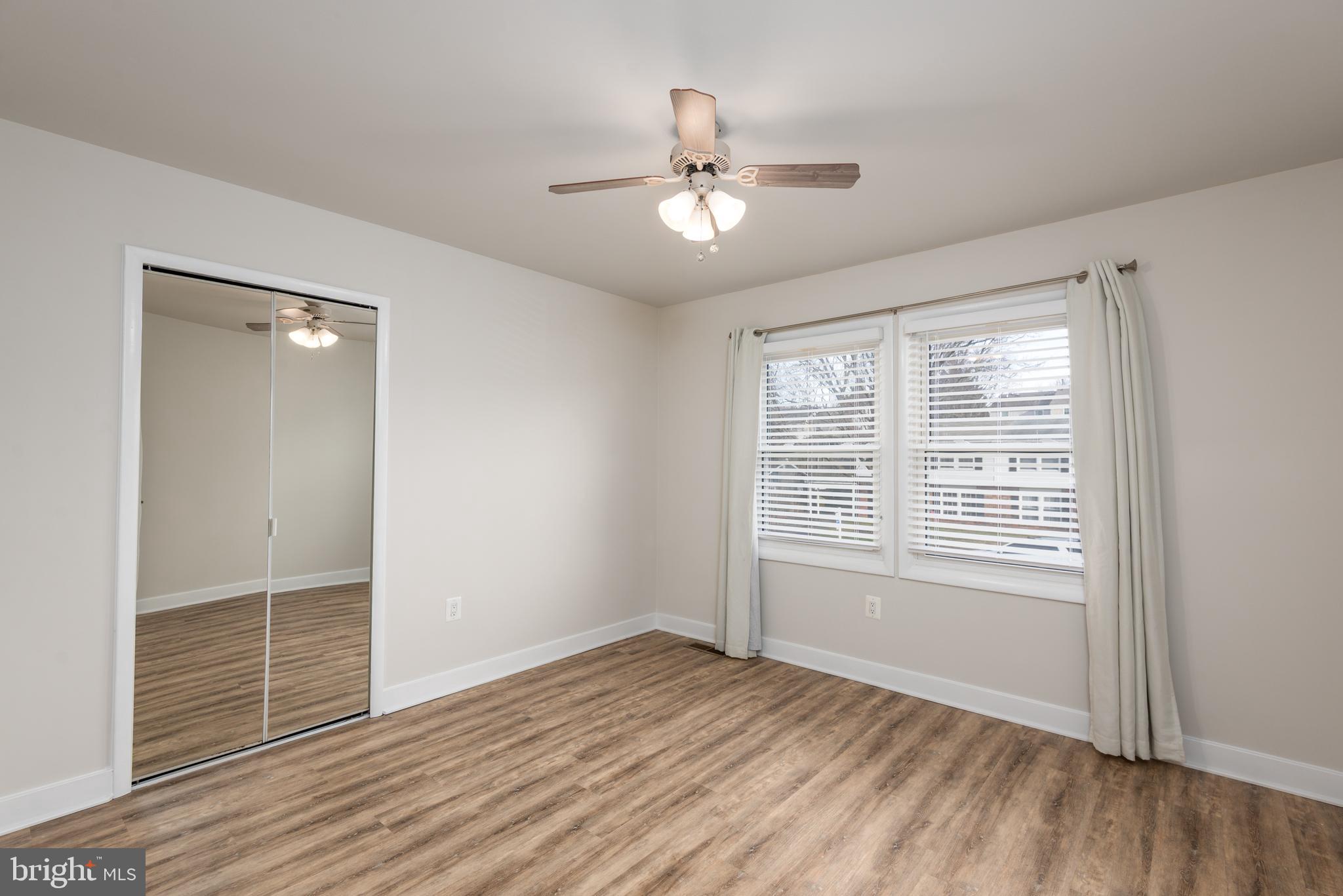724 Chapelgate Drive Odenton, MD 21113 - Photo 15 of 26 a view of an empty room with wooden floor and a window