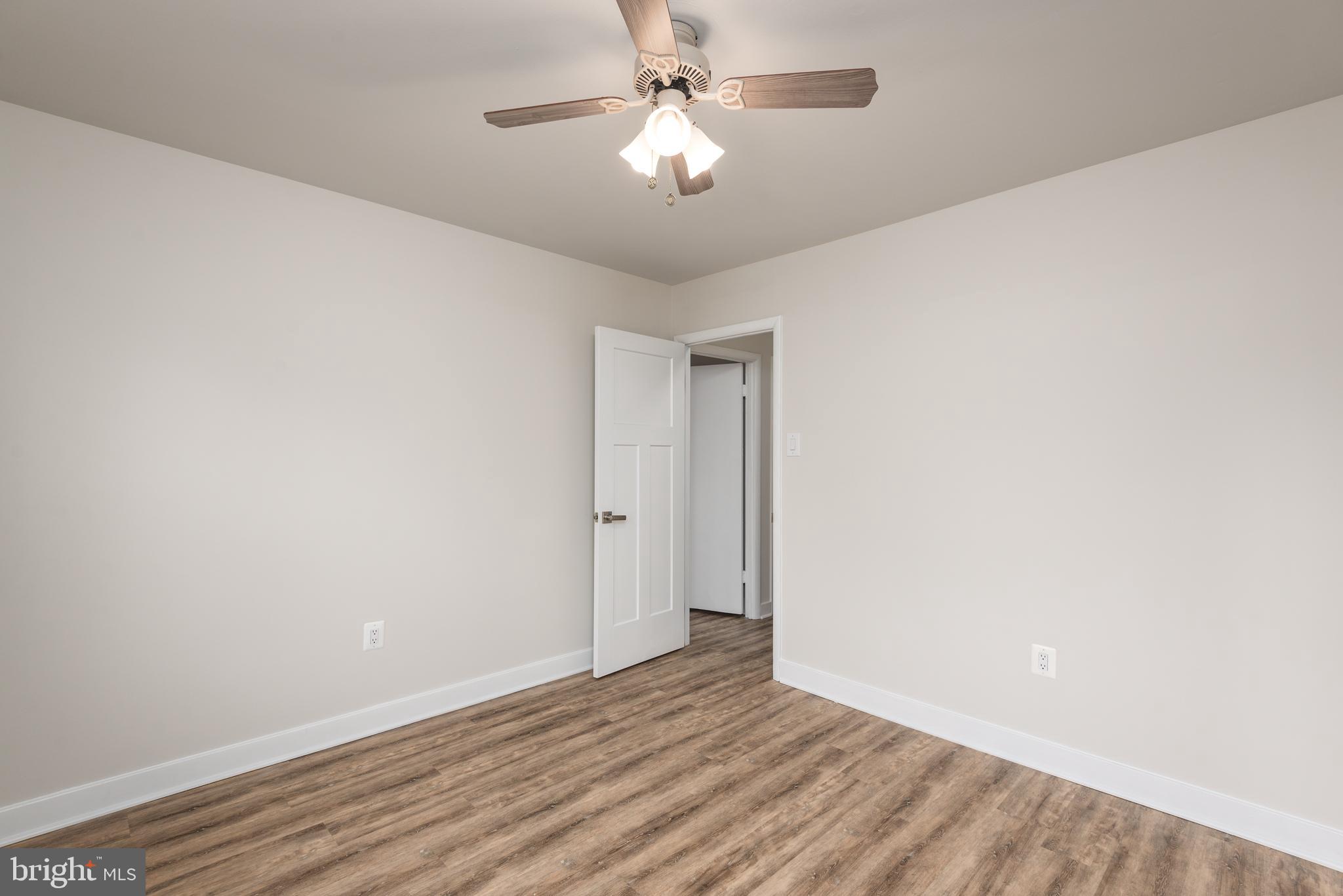 724 Chapelgate Drive Odenton, MD 21113 - Photo 16 of 26 a view of a room with wooden floor and a ceiling fan