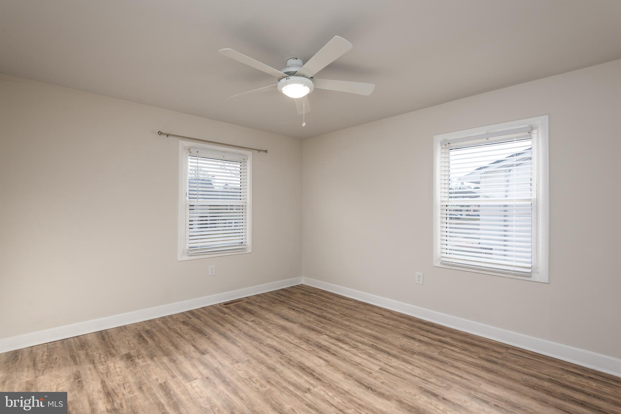724 Chapelgate Drive Odenton, MD 21113 - Photo 17 of 26 a view of an empty room with wooden floor and a window