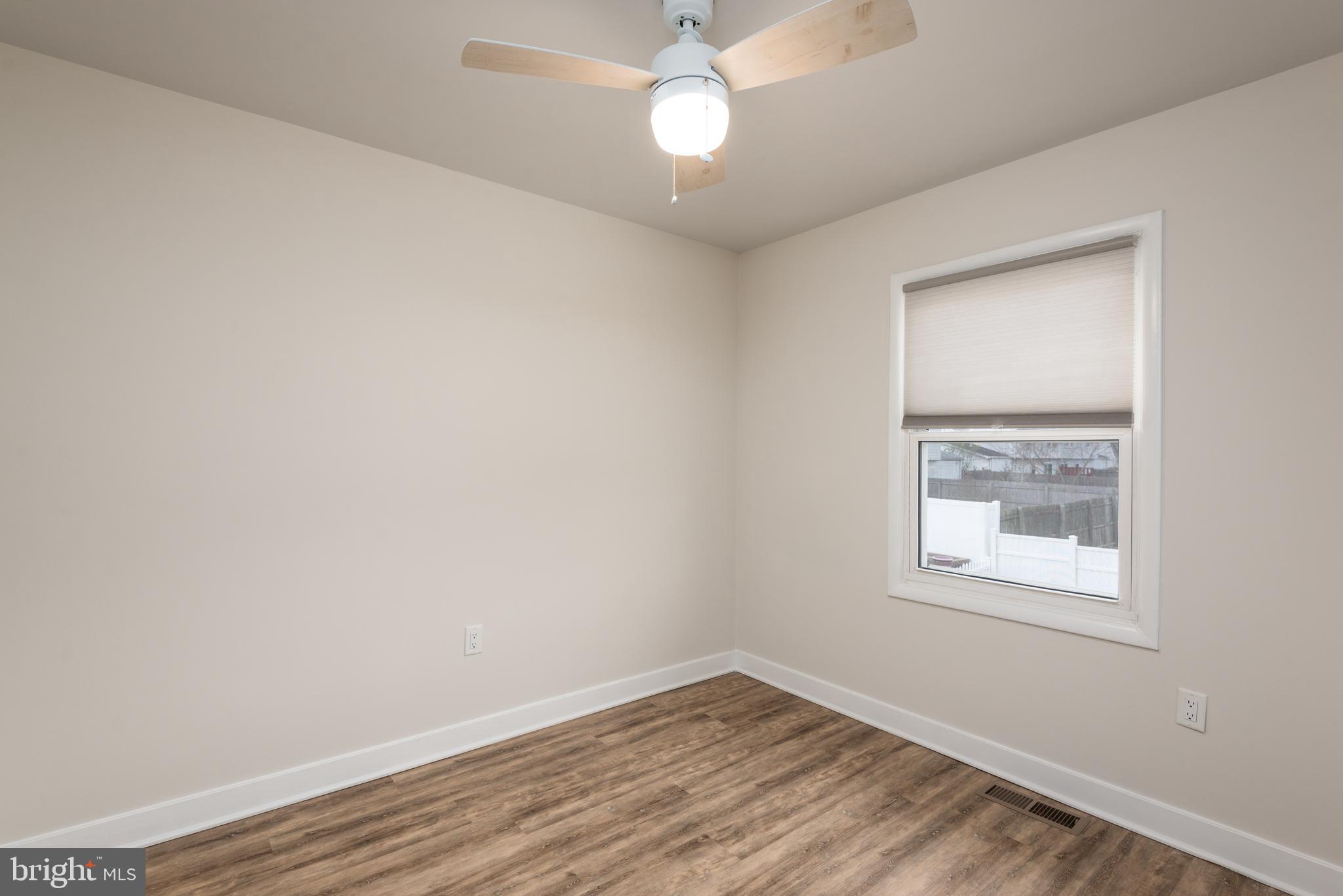 724 Chapelgate Drive Odenton, MD 21113 - Photo 19 of 26 an empty room with a window and wooden floor