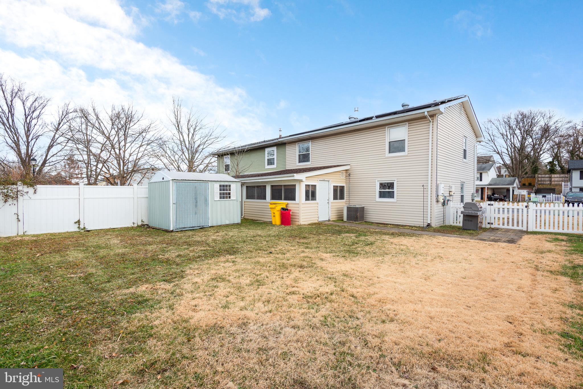 724 Chapelgate Drive Odenton, MD 21113 - Photo 3 of 26 a view of a white house with a big yard and large trees