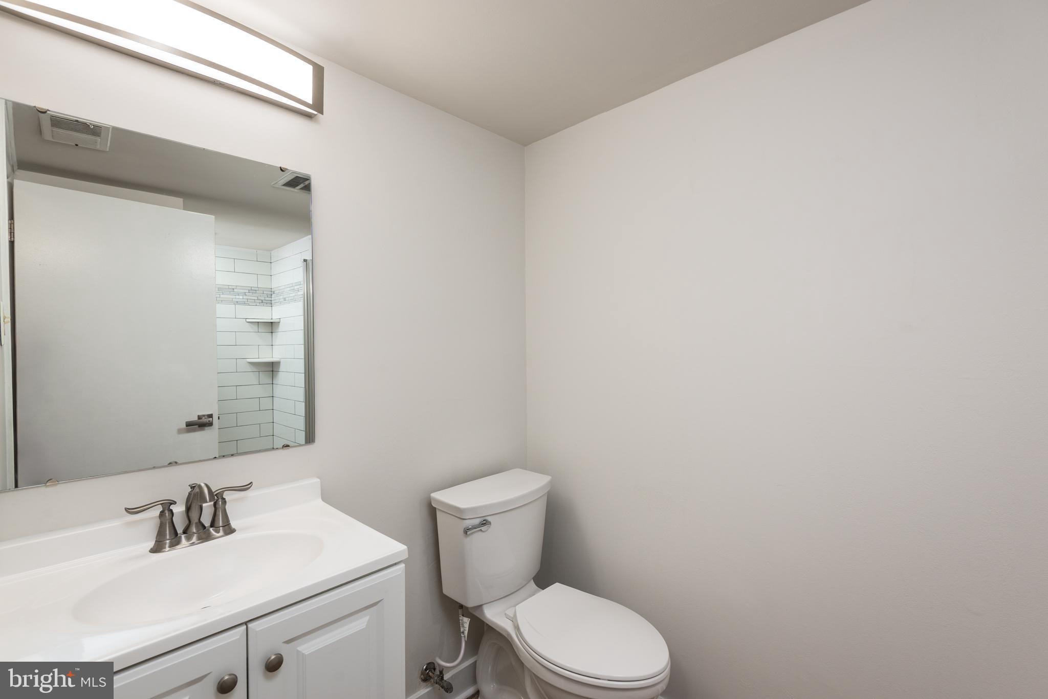 724 Chapelgate Drive Odenton, MD 21113 - Photo 8 of 26 a white toilet sitting next to a bathroom sink