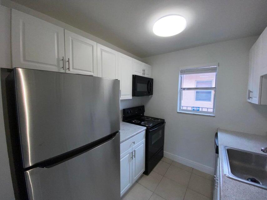 550 Southwest 2nd Avenue, Unit 224 Boca Raton, FL 33432 - Photo 1 of 33 a kitchen with stainless steel appliances granite countertop a refrigerator stove and microwave