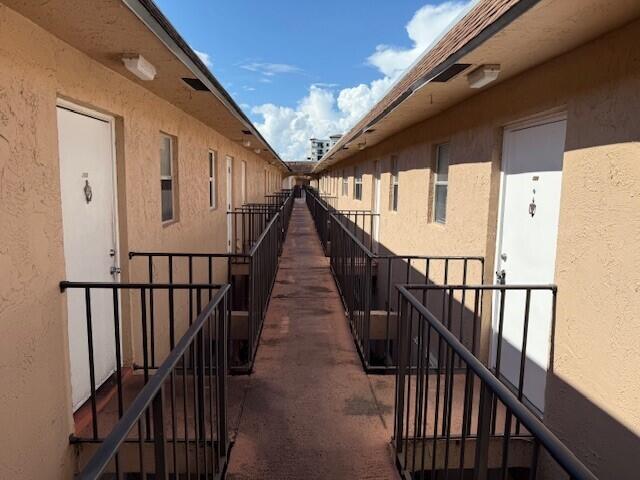 550 Southwest 2nd Avenue, Unit 224 Boca Raton, FL 33432 - Photo 2 of 33 a view of staircase with lots of frames on wall and wooden floor