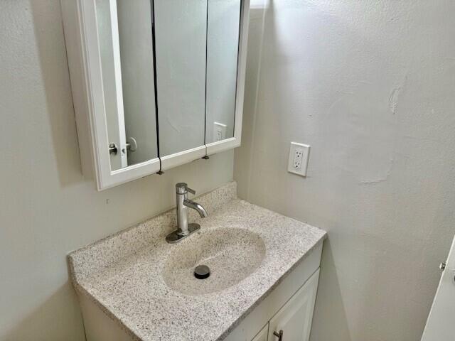 550 Southwest 2nd Avenue, Unit 224 Boca Raton, FL 33432 - Photo 22 of 33 a bathroom with a granite countertop sink and a mirror