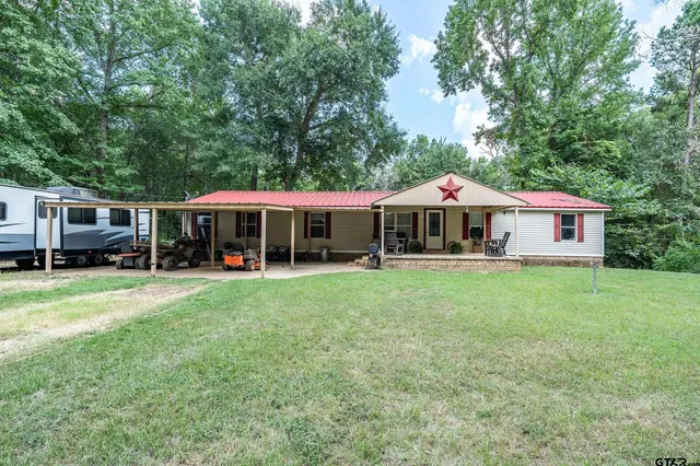 a front view of a house with a yard table and chairs