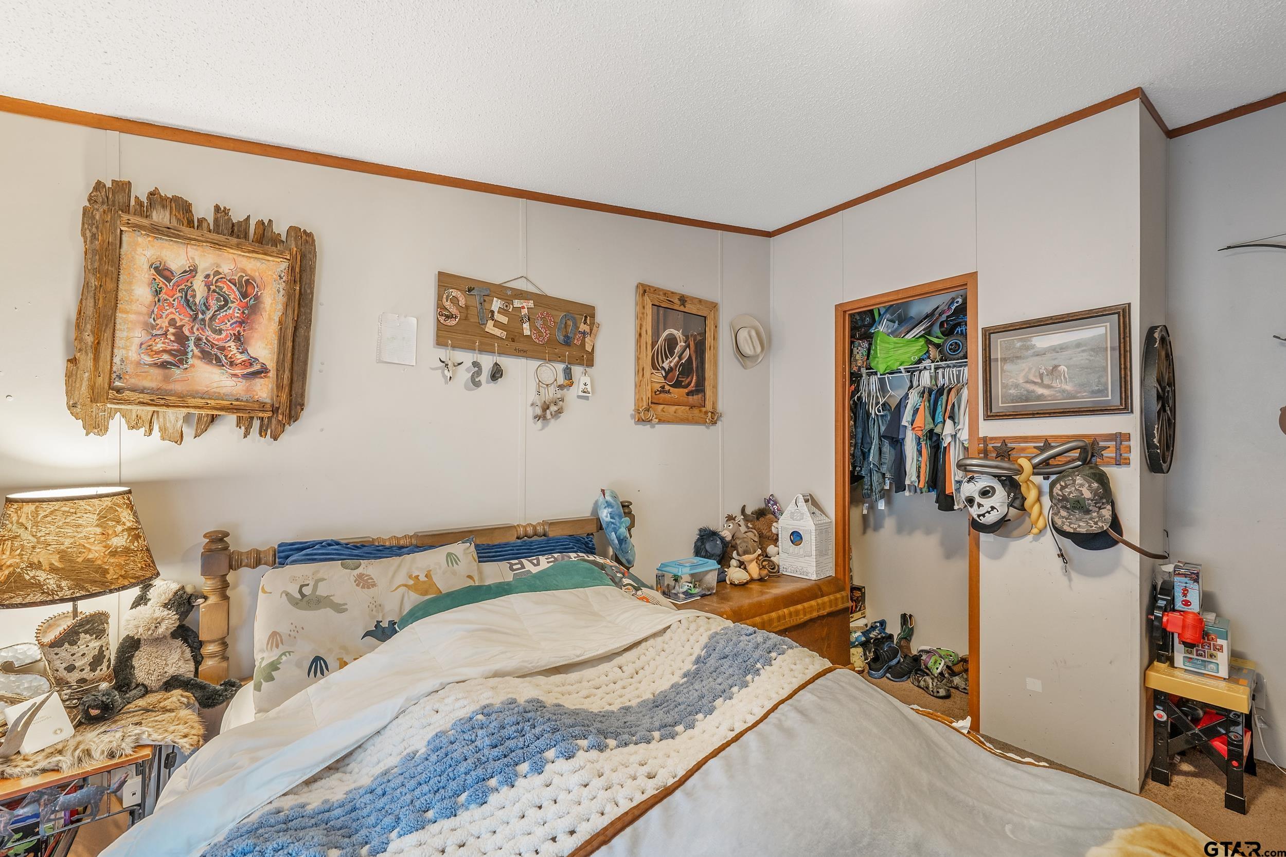 1655 County Road 2120 Rusk, TX 75785 - Photo 19 of 37 a bedroom with a bed and wooden floor