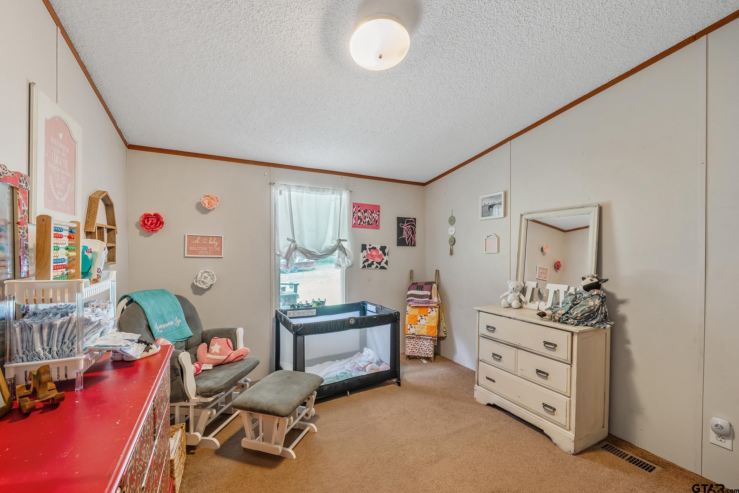 1655 County Road 2120 Rusk, TX 75785 - Photo 22 of 37 a room with furniture and a dresser