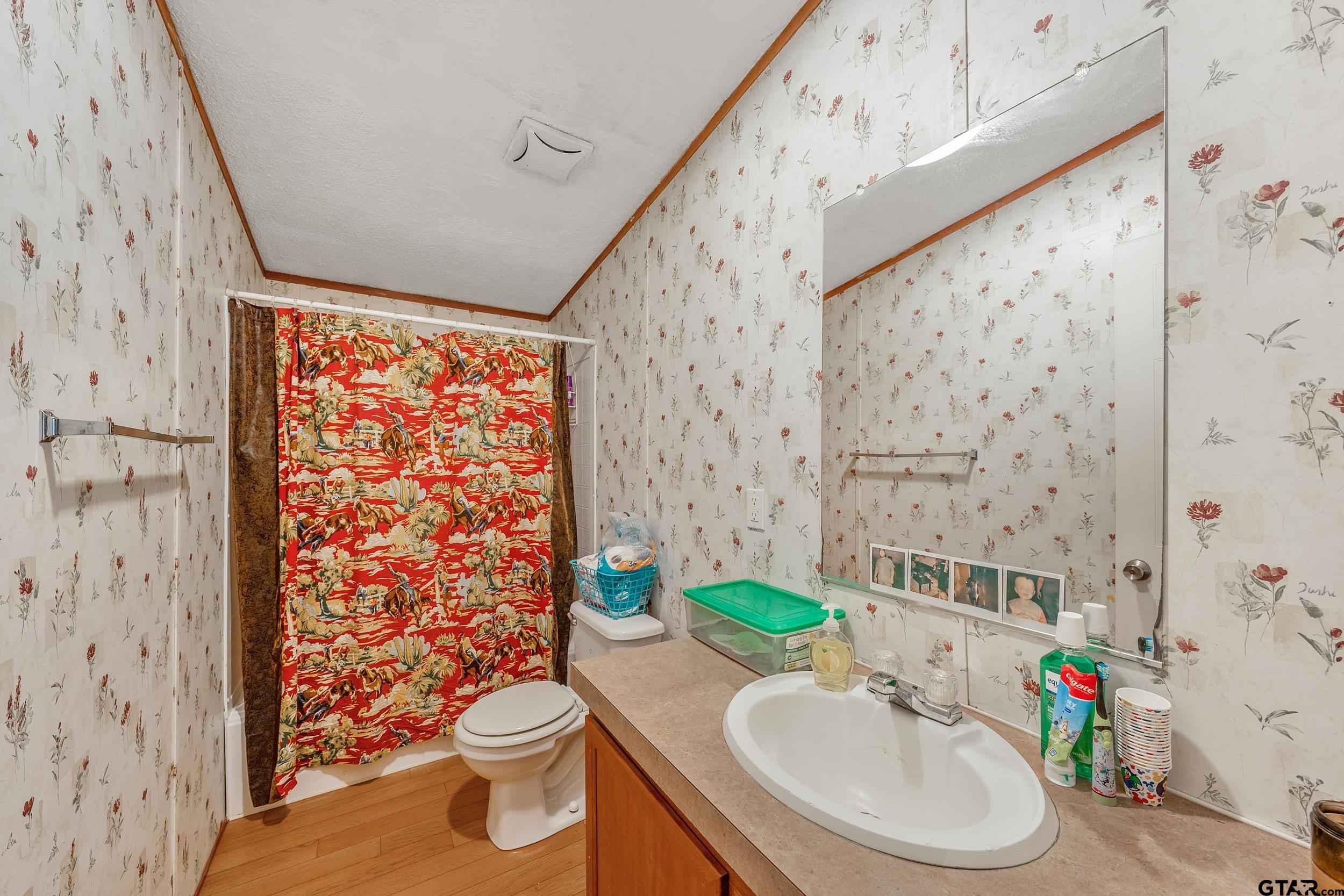 1655 County Road 2120 Rusk, TX 75785 - Photo 24 of 37 a bathroom with a sink toilet and shower