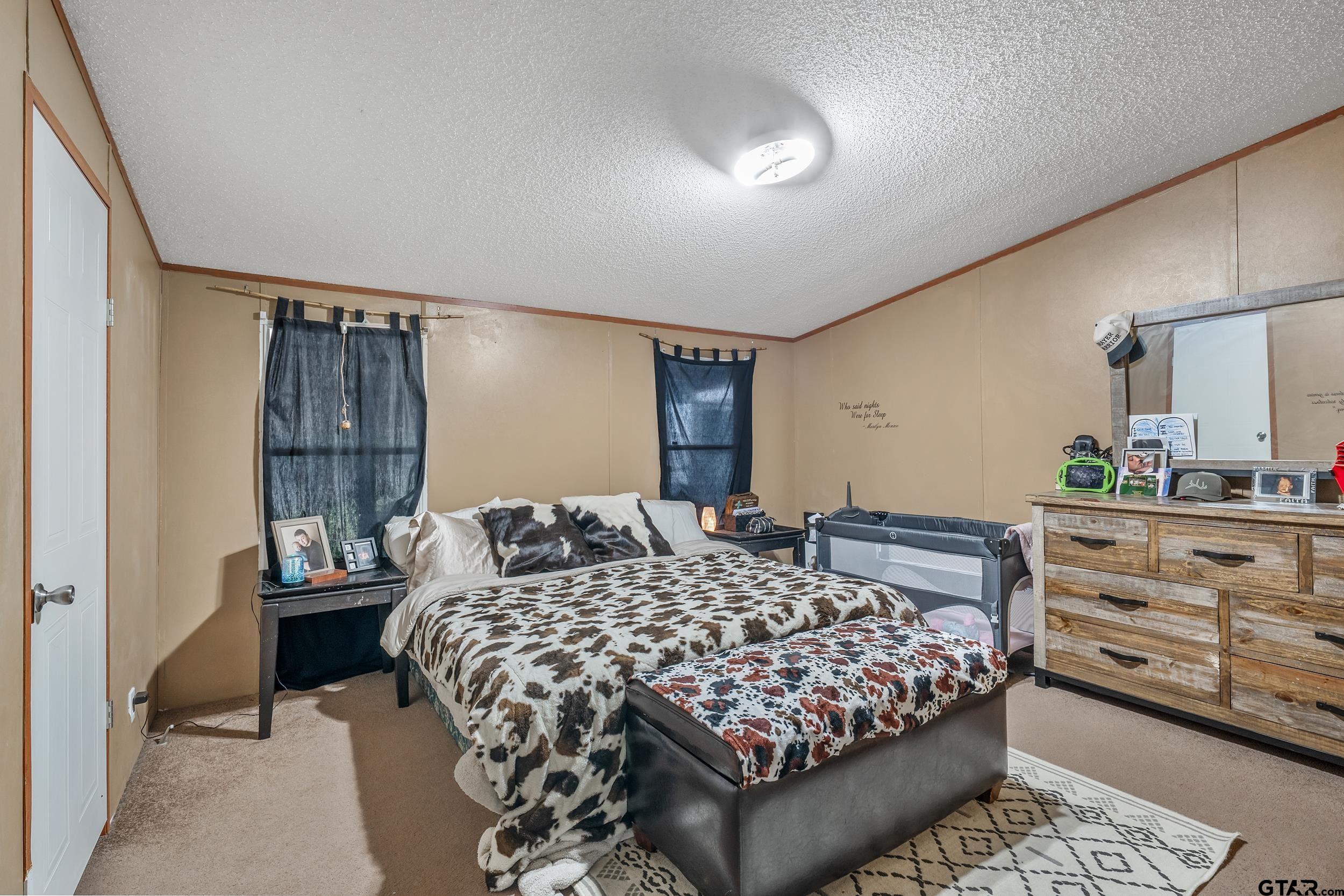1655 County Road 2120 Rusk, TX 75785 - Photo 25 of 37 a bedroom with a large bed and a dresser
