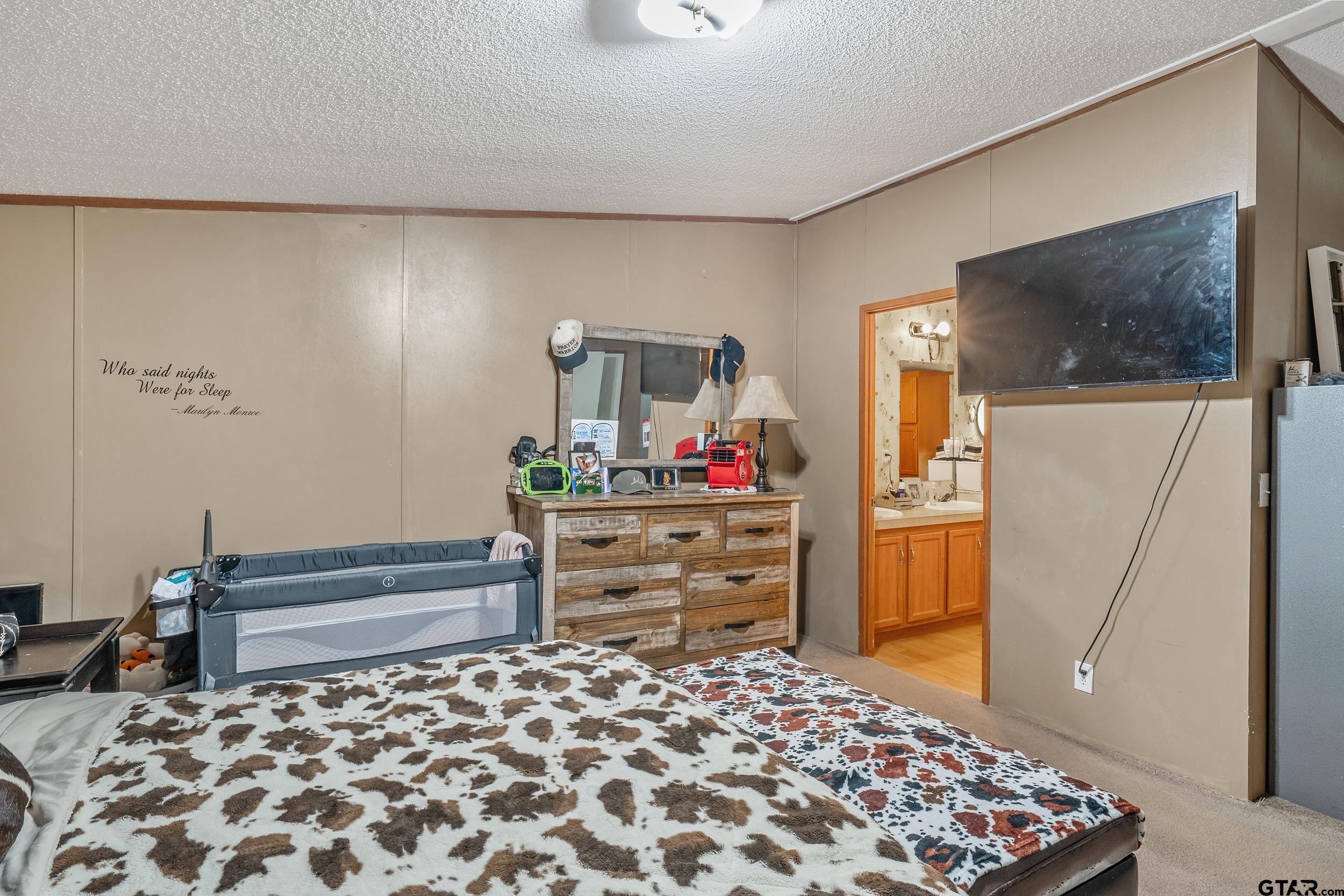 1655 County Road 2120 Rusk, TX 75785 - Photo 26 of 37 a bedroom with a bed and a dresser