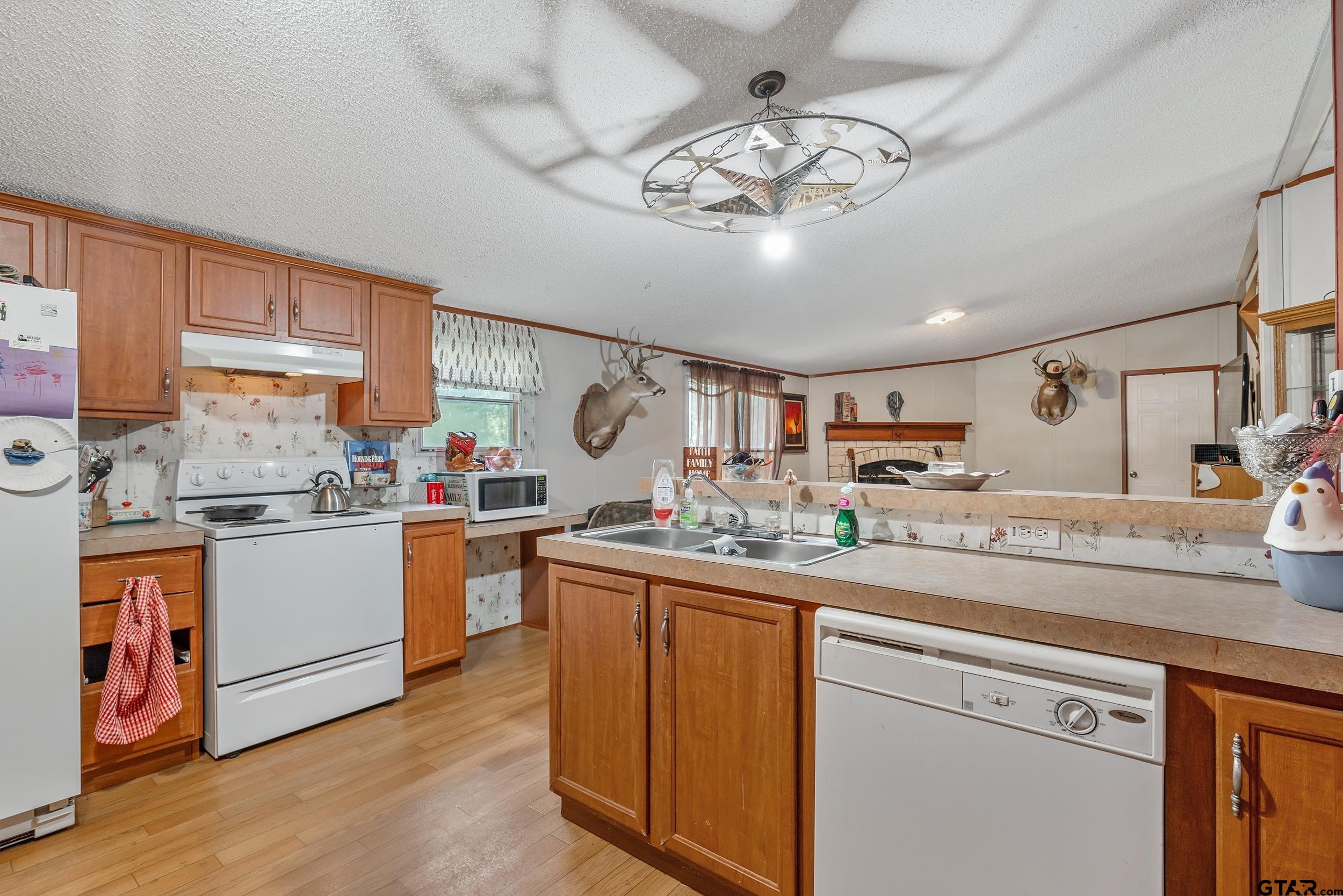 1655 County Road 2120 Rusk, TX 75785 - Photo 31 of 37 a kitchen with a sink cabinets and wooden floor