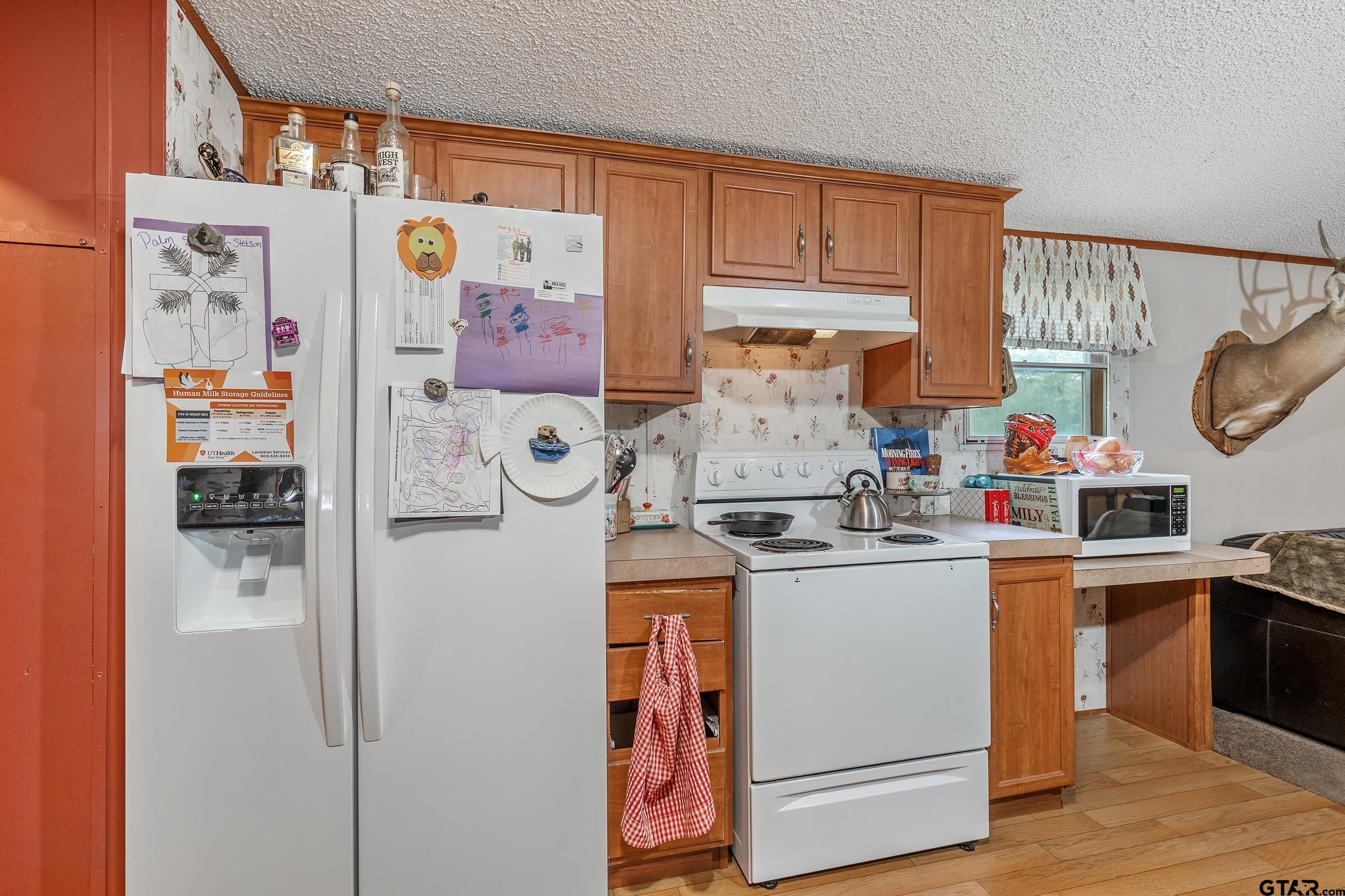 1655 County Road 2120 Rusk, TX 75785 - Photo 32 of 37 a kitchen with stainless steel appliances granite countertop a stove and a refrigerator