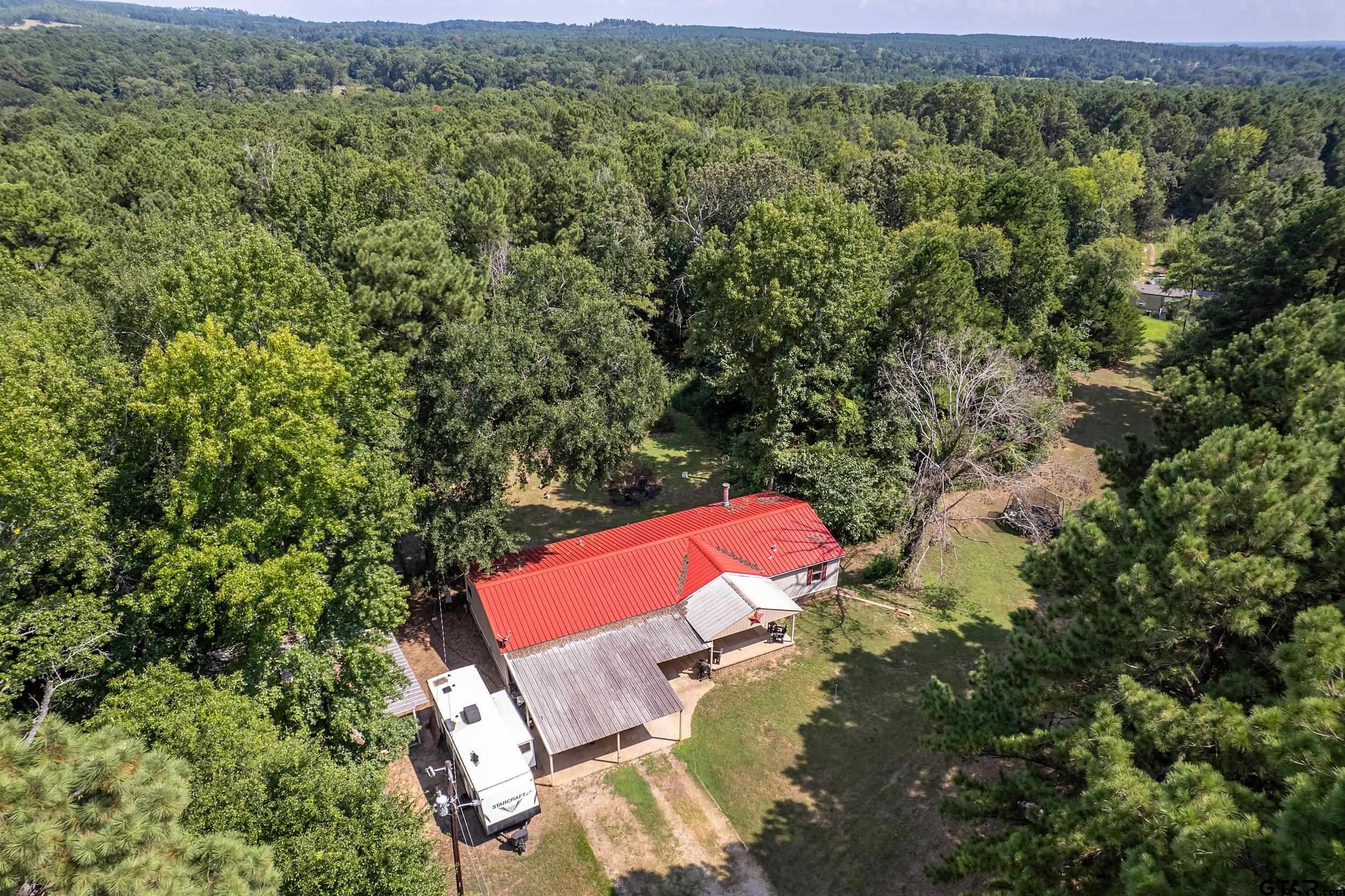 1655 County Road 2120 Rusk, TX 75785 - Photo 4 of 37 an aerial view of a house with a yard